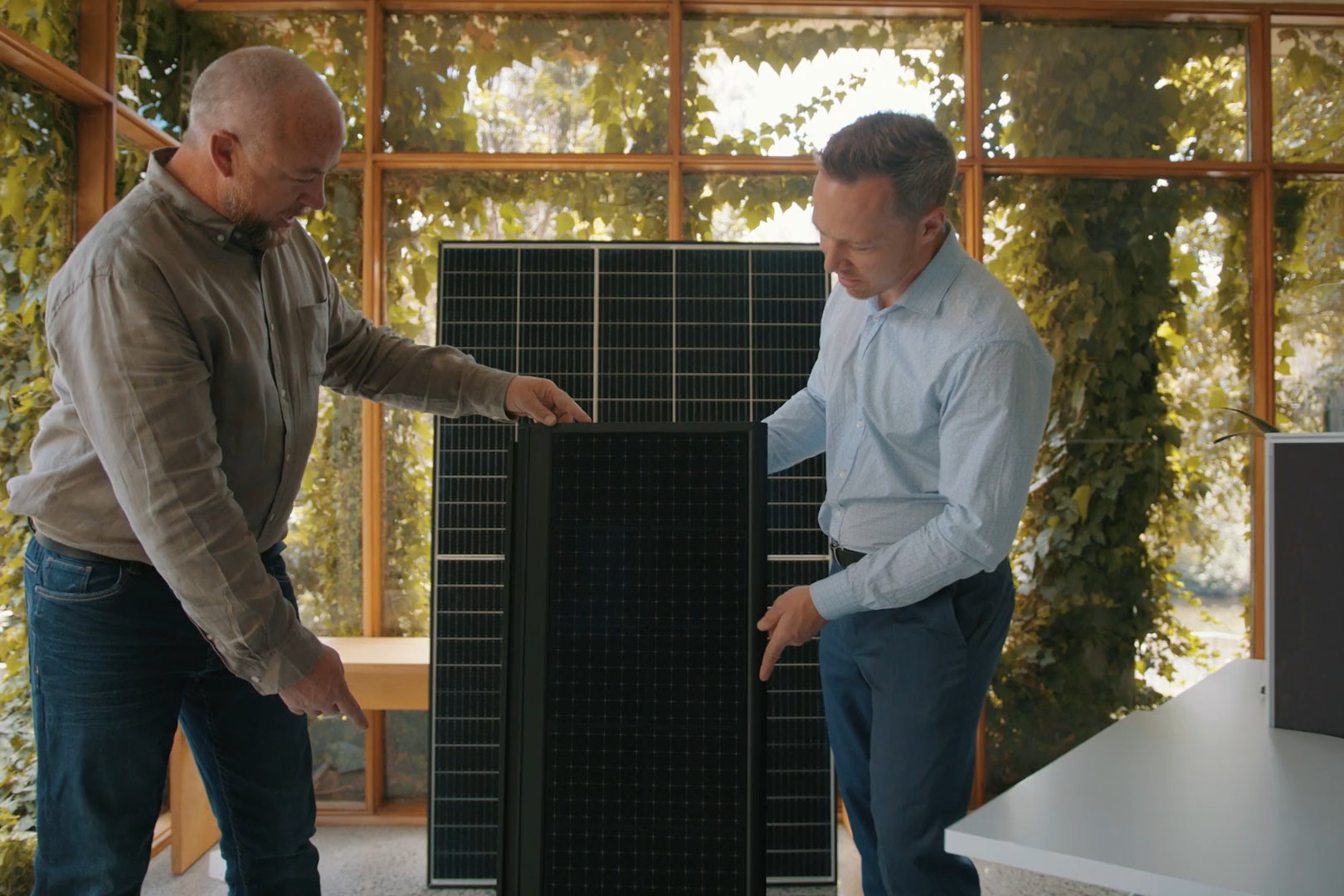 Two of the Volt team comparing a solar module against the Volt tile